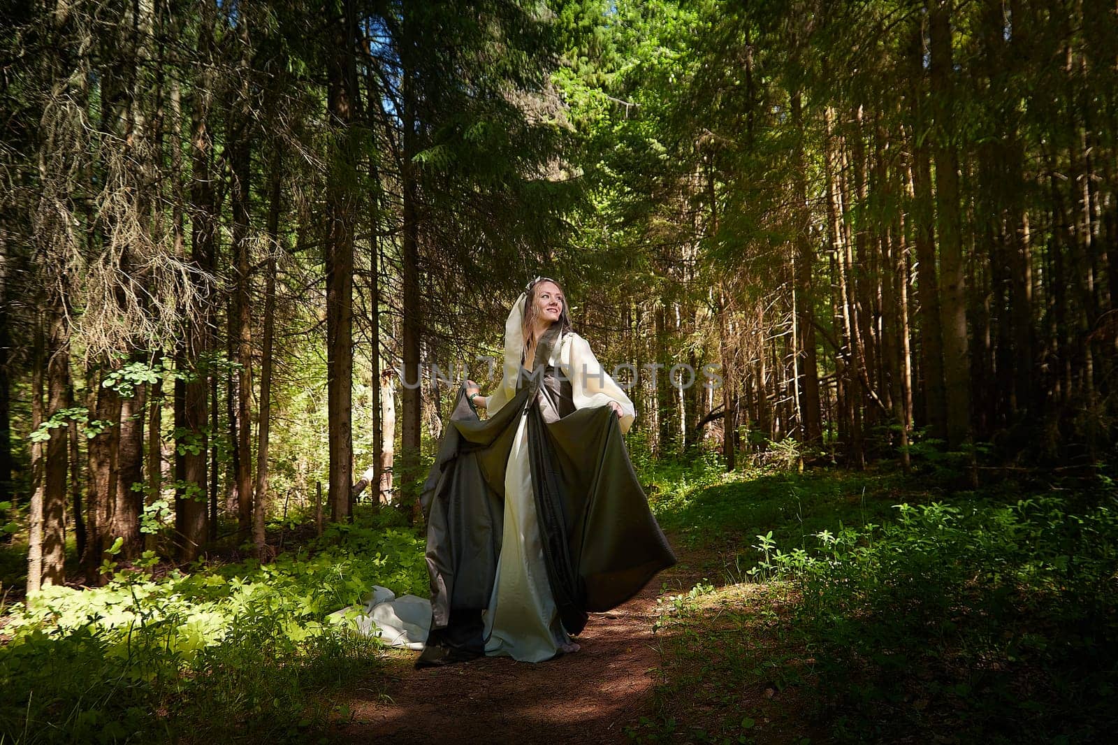 Beautiful seductive dryad. Pagan spirit of forest. Portrait of beautiful dryad. Fairy who loves nature in beautiful green summer forest. Concept of environmental friendliness and caring for nature