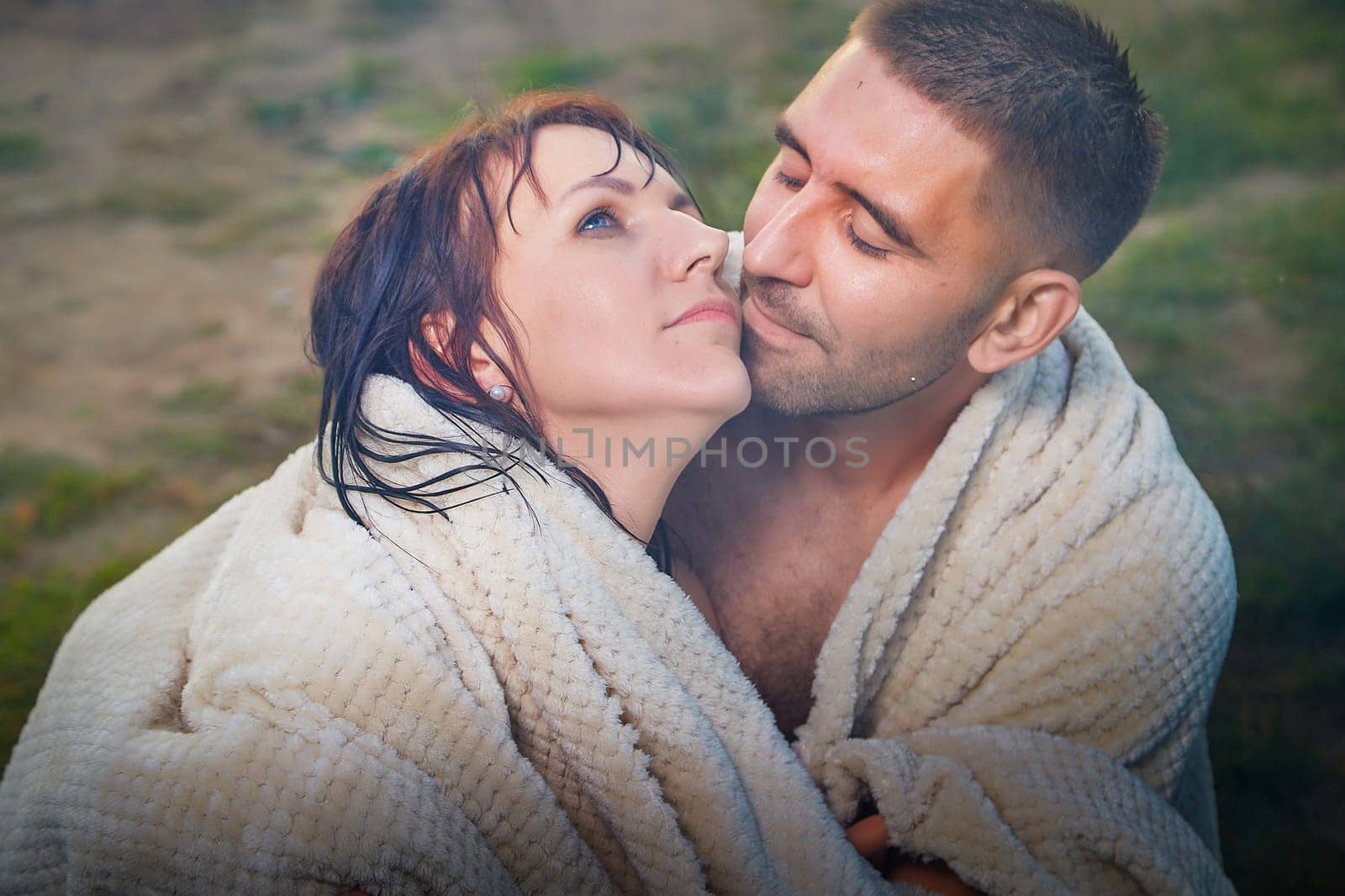 Happy Couple Outdoor relaxin, having fun and hugs on nature in the park in summer day with smog and fog. Family or lovers have date and rest outdoors. Concept of love and friendship by keleny