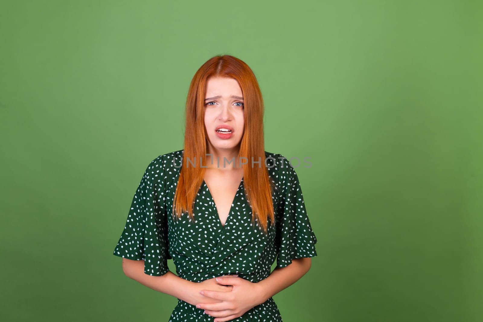 Young red hair woman on green background sad suffering from stomach pain by kroshka_nastya