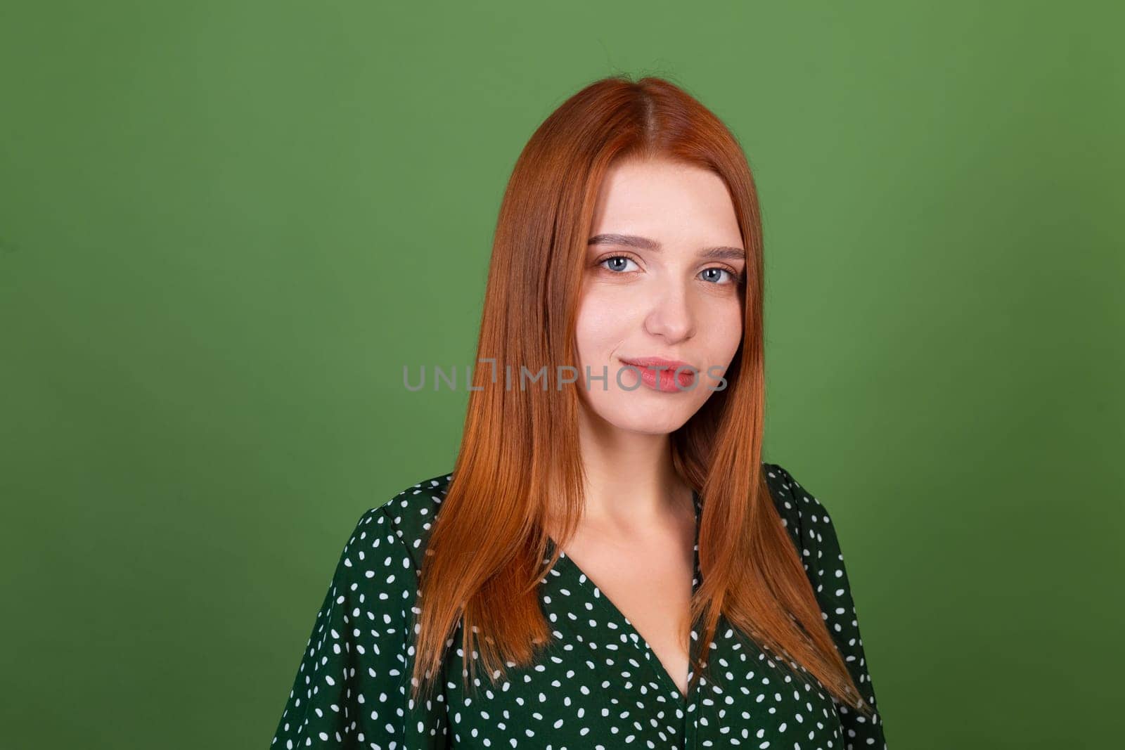 Young red hair woman on green background with confident smile look to camera by kroshka_nastya