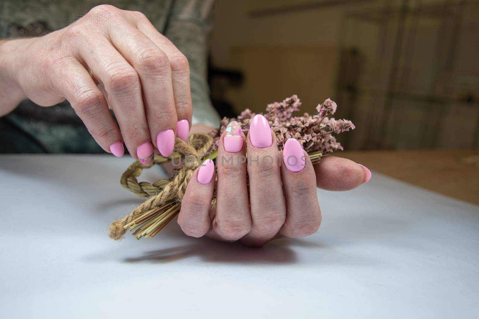 a young woman with a beautiful pink spring manicure holds a bouquet of flowers, High quality photo