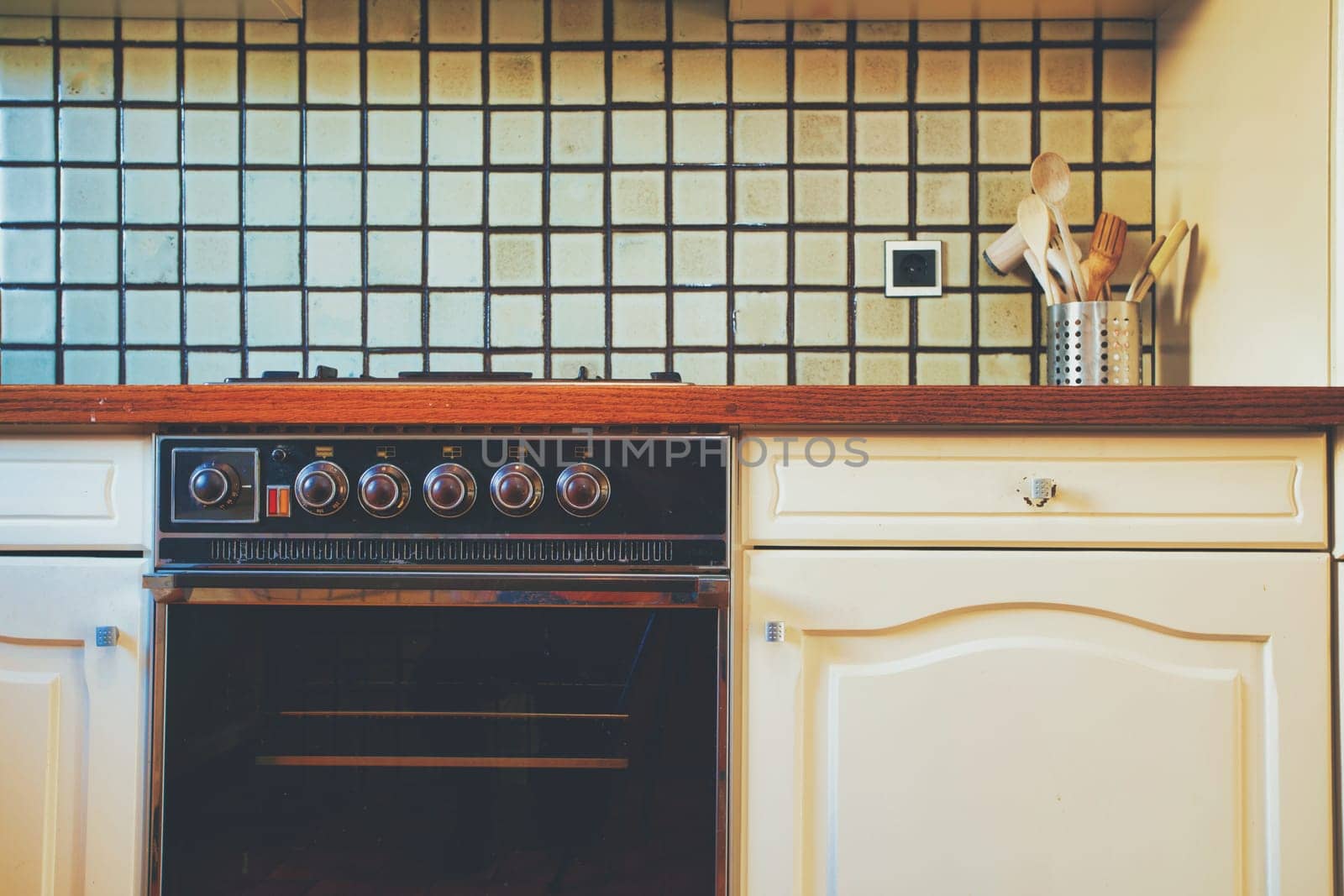 Vintage retro kitchen with green pattern tiles, american retro kitchen home interior design 70's 80's style close-up. retro background