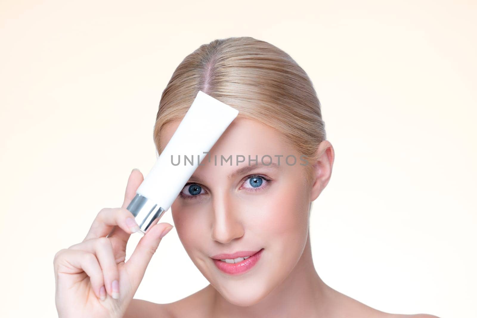 Closeup personable beautiful perfect natural skin woman hold mockup tube moisturizer cream for skincare treatment product advertising expressive facial and gesture expression in isolated background.