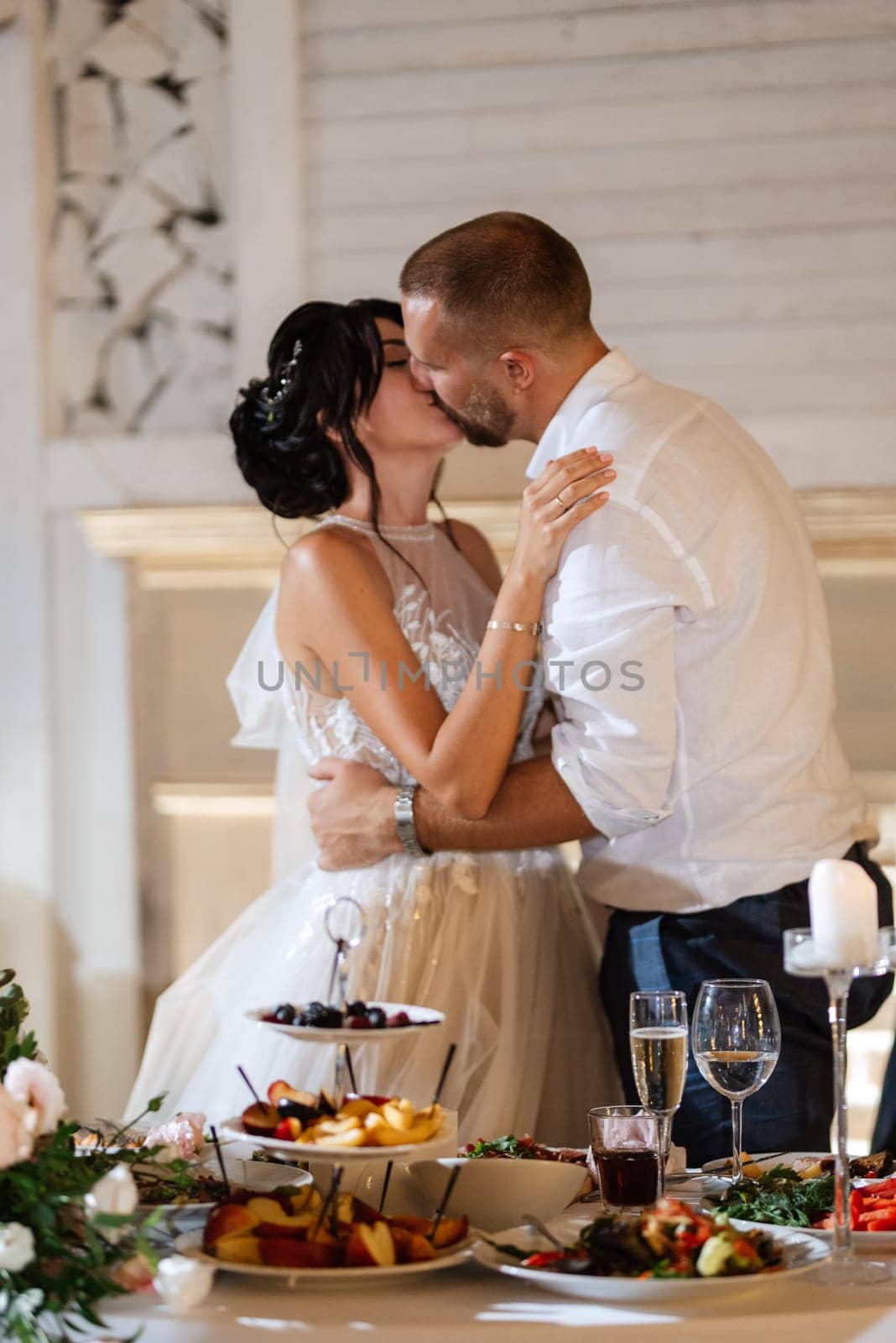 newlyweds happily cut and taste the wedding cake by Andreua