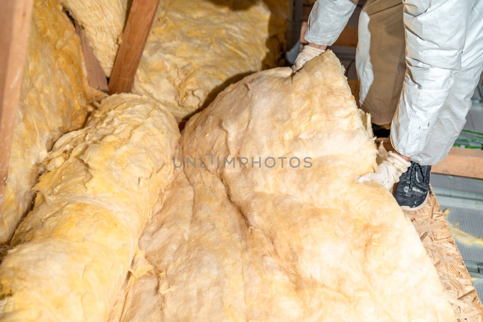 work on the attic of the house, insulated with glass wool. High quality photo