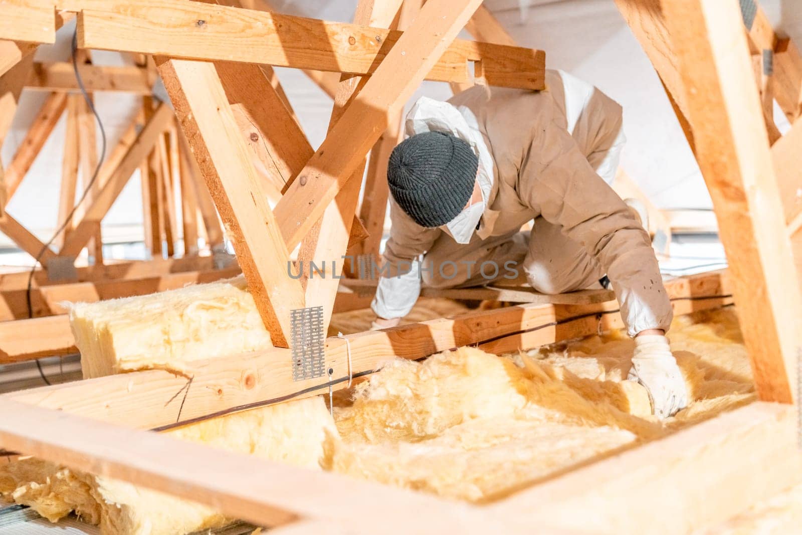 work on the attic of the house, insulated with glass wool. High quality photo