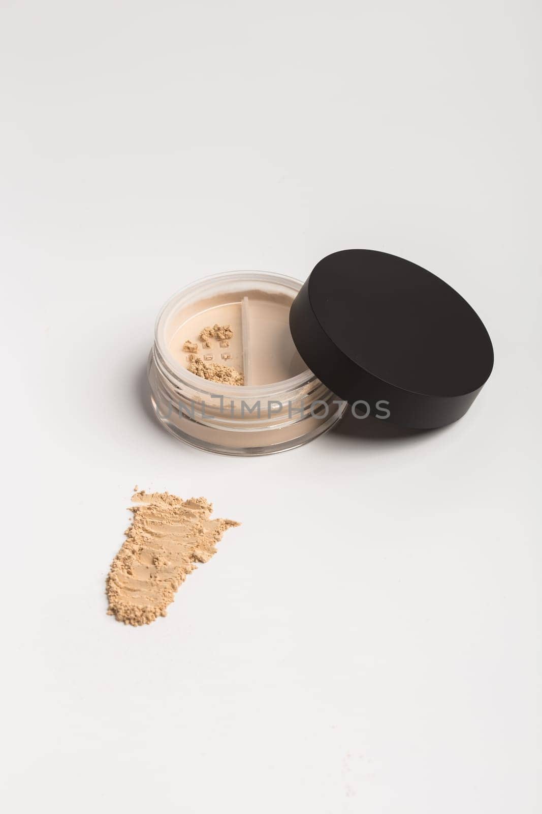 Mineral makeup powder twist seal sifter isolated on white background. Light beige foundation powder. Skin tone face cosmetic product sample by Satura86