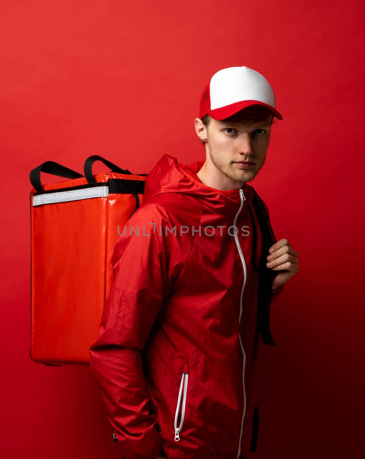 Delivery man with thermo backpack smiling at camera. Food delivery service. Fast express home delivery. Online order