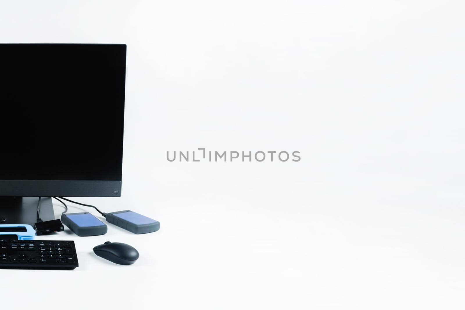 Multiple external hard drives connected to a monoblock on a white background.Computer with hard drive.