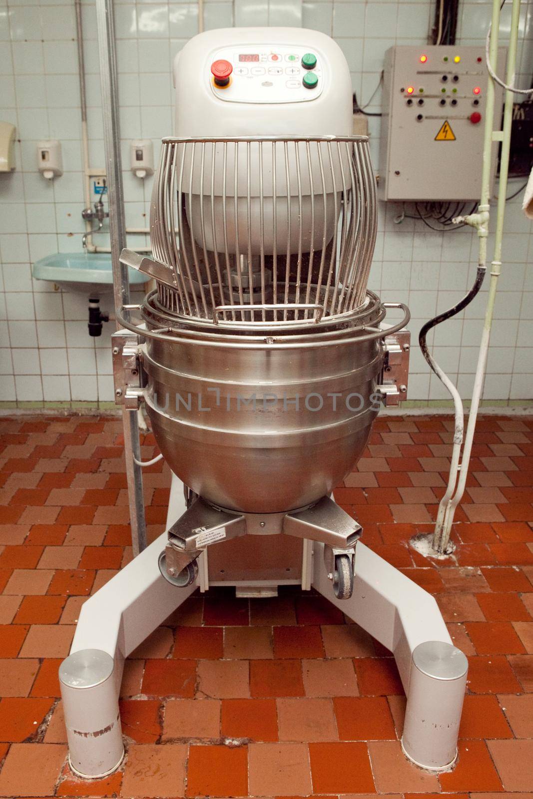 The process of making cookie dough in an industrial kneading machine at the factory.