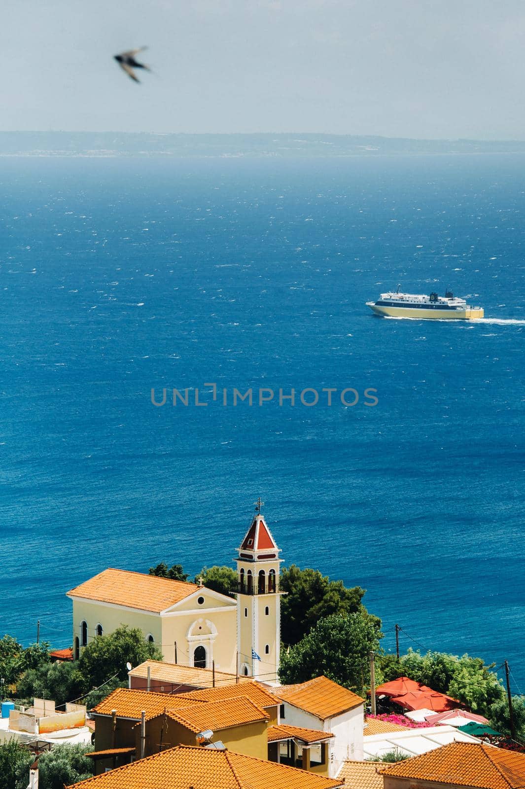 view from the height of the Church of the island of Zakynthos.In the distance, a ferry sails across the Ionian sea. the island of Zakynthos, Greece.