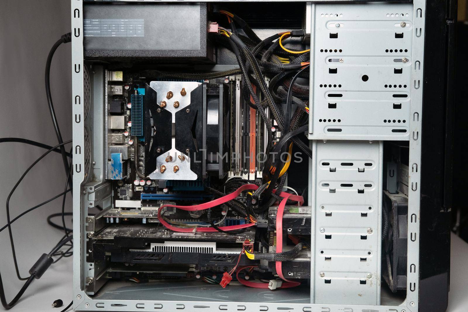 The system unit of the computer is disassembled without a cover.Lots of old computer parts. computer from the inside.