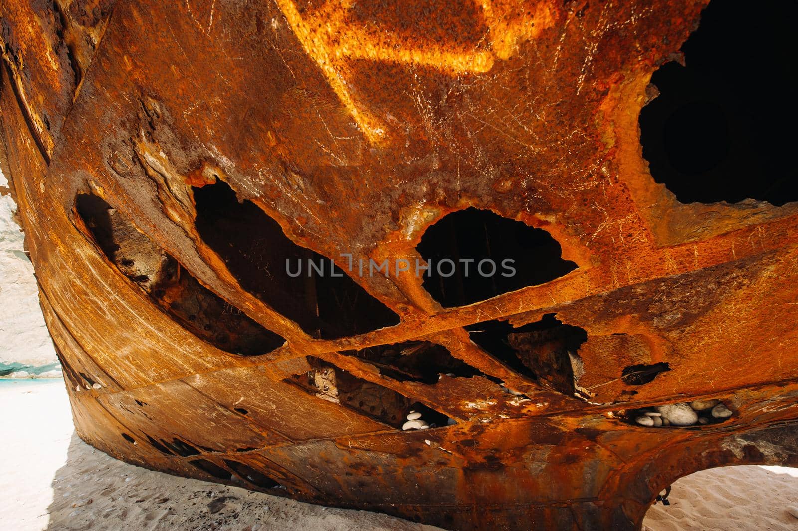 Rusted with holes, the ship is on the sea shore.Rusty ship in the Bay of Navagio on the island of Zakynthos.