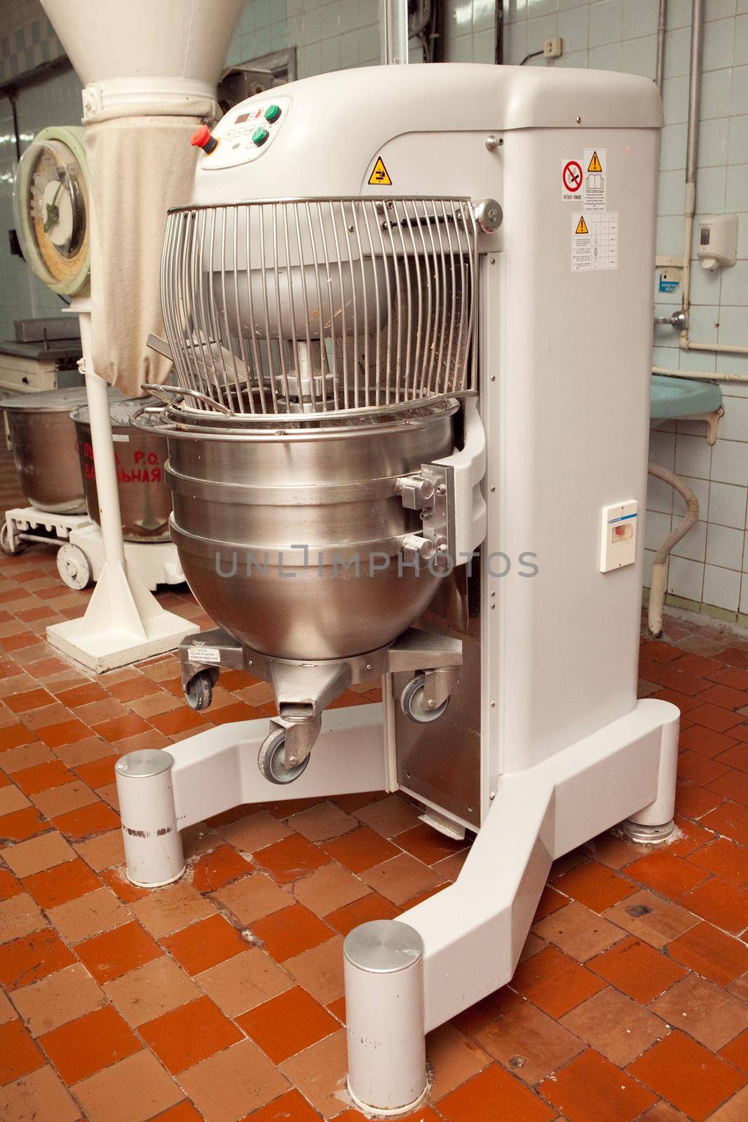 The process of making cookie dough in an industrial kneading machine at the factory.