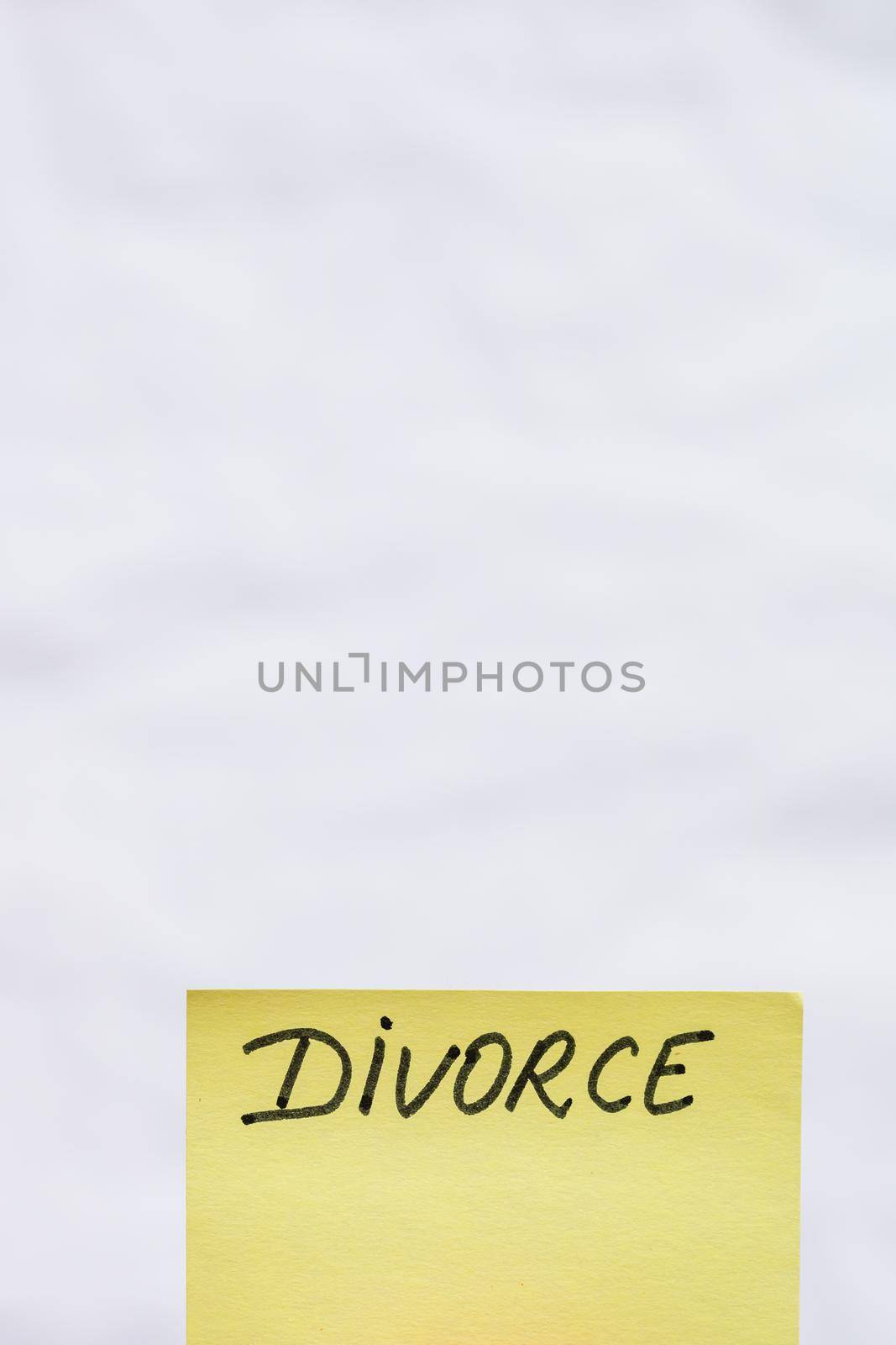  Divorce handwriting text close up isolated on yellow paper with copy space. by vladispas