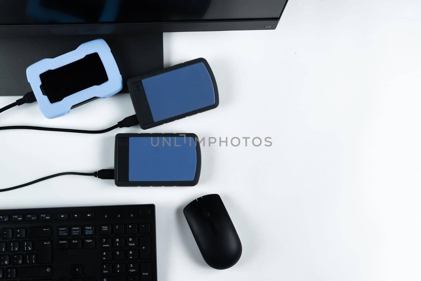 Multiple external hard drives connected to a monoblock on a white background.Computer with hard drive.