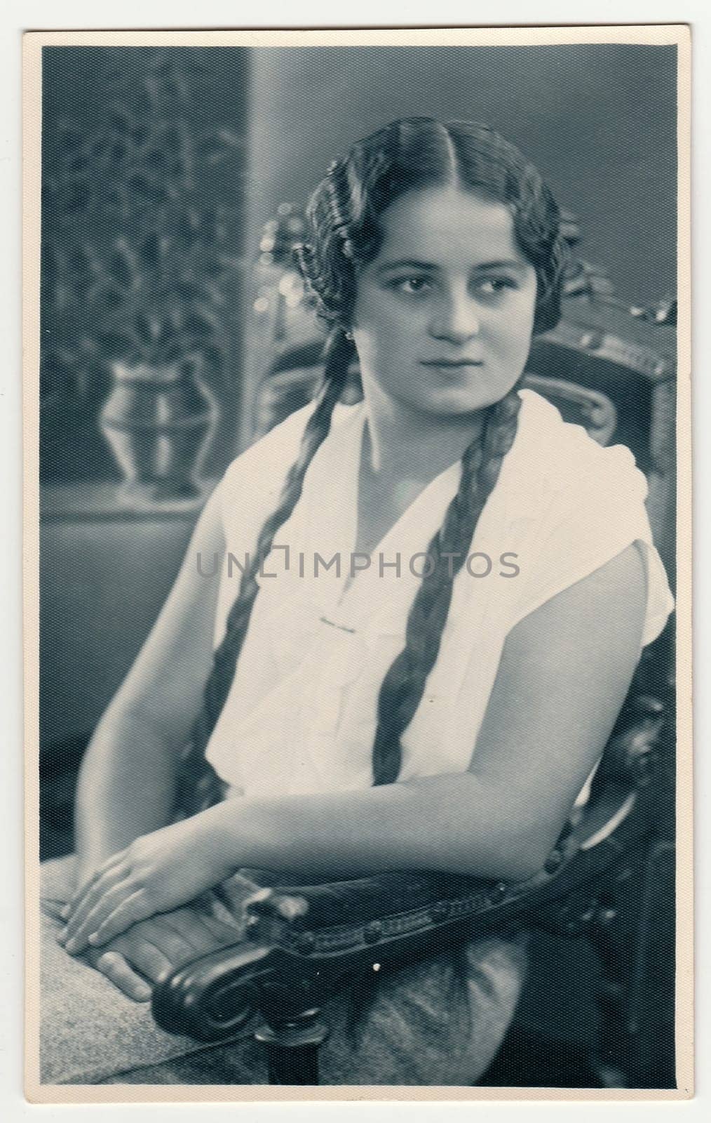 Vintage portrait photo shows girl sits on a chair. Photo studio portrait, October 15, 1932. by roman_nerud