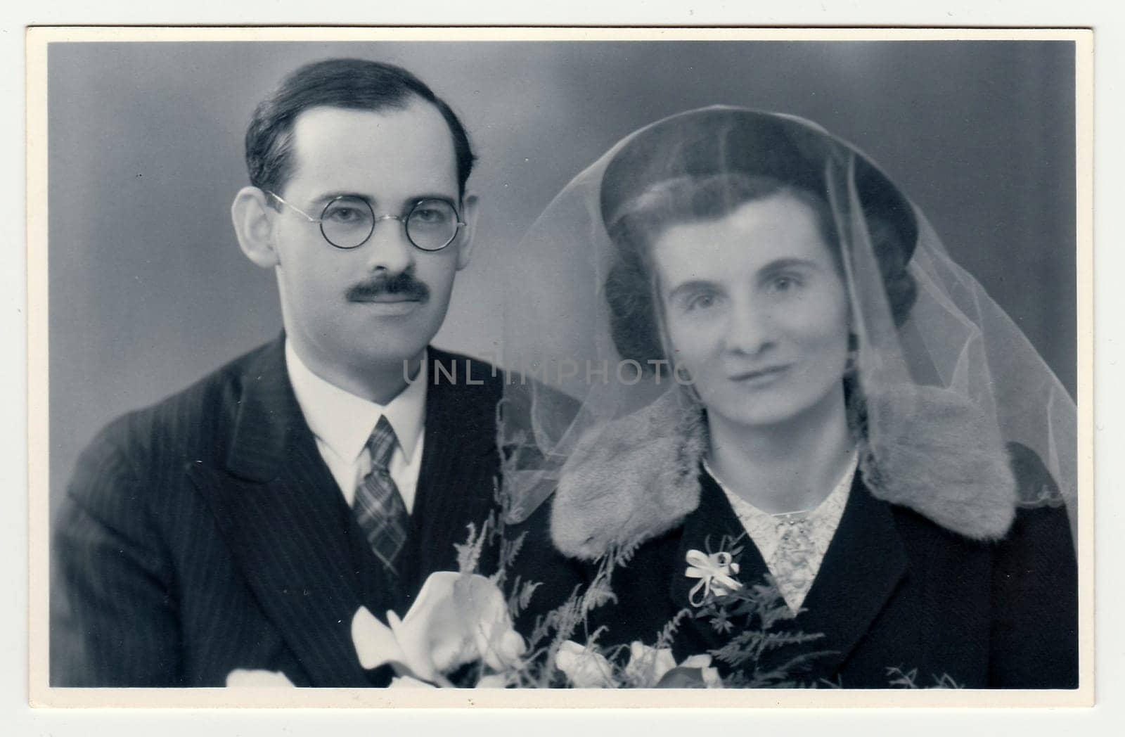 A vintage photo shows wedding portrait of newly-weds, circa 1935. by roman_nerud