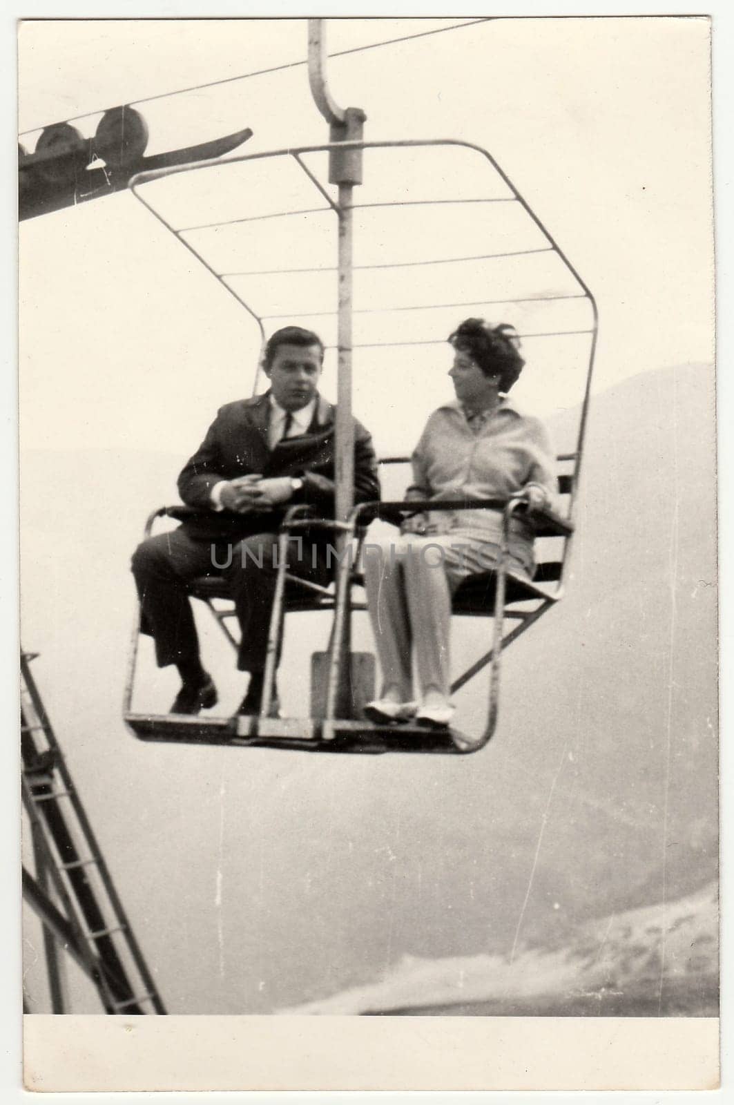 Retro photo of a marrital couple on a chair lift, 1970s. by roman_nerud
