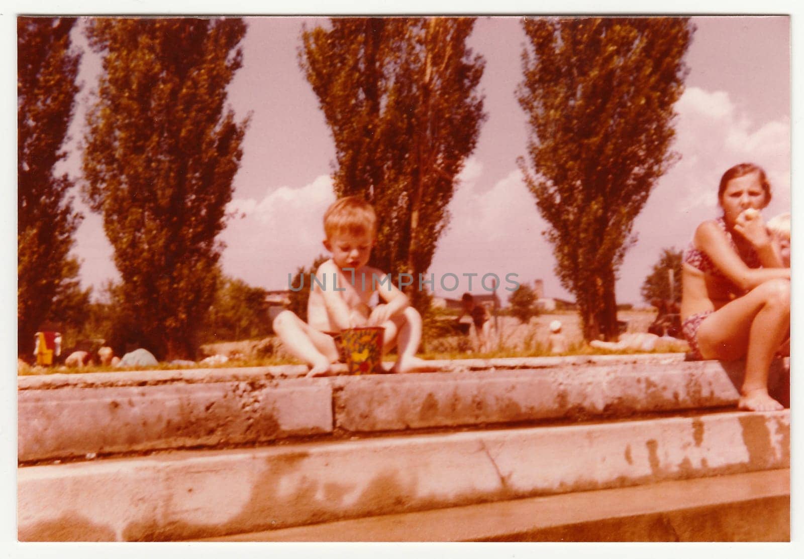 Vintage photo shows a small boy on a public swimming pool, circa 1974. by roman_nerud