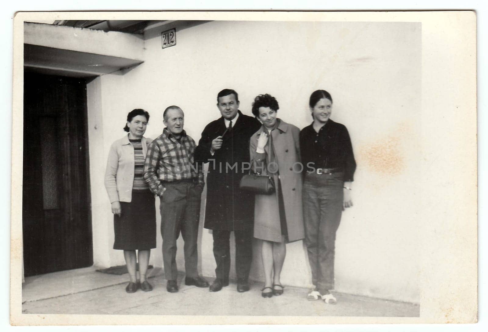 THE CZECHOSLOVAK SOCIALIST REPUBLIC, 1970:s Vintage photo shows a group of people in front of house, 1970s.