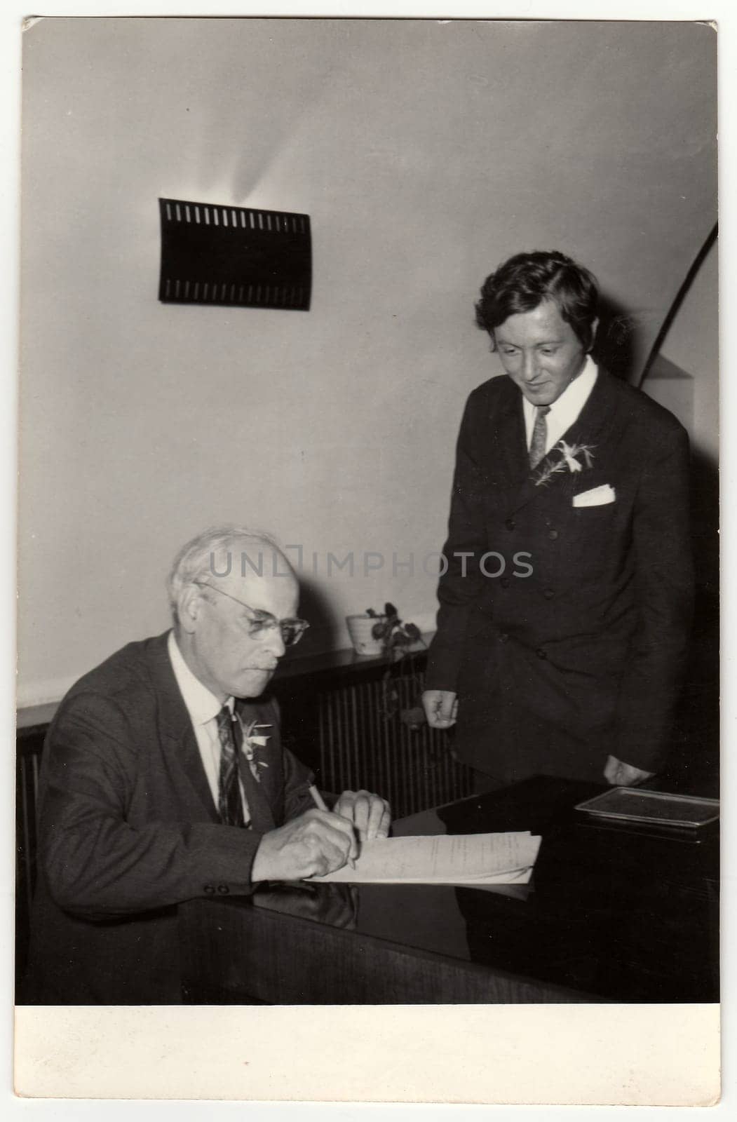 THE CZECHOSLOVAK SOCIALIST REPUBLIC, CIRCA 1970: A vintage photo shows grandfather to signature wedding documents, circa 1970.