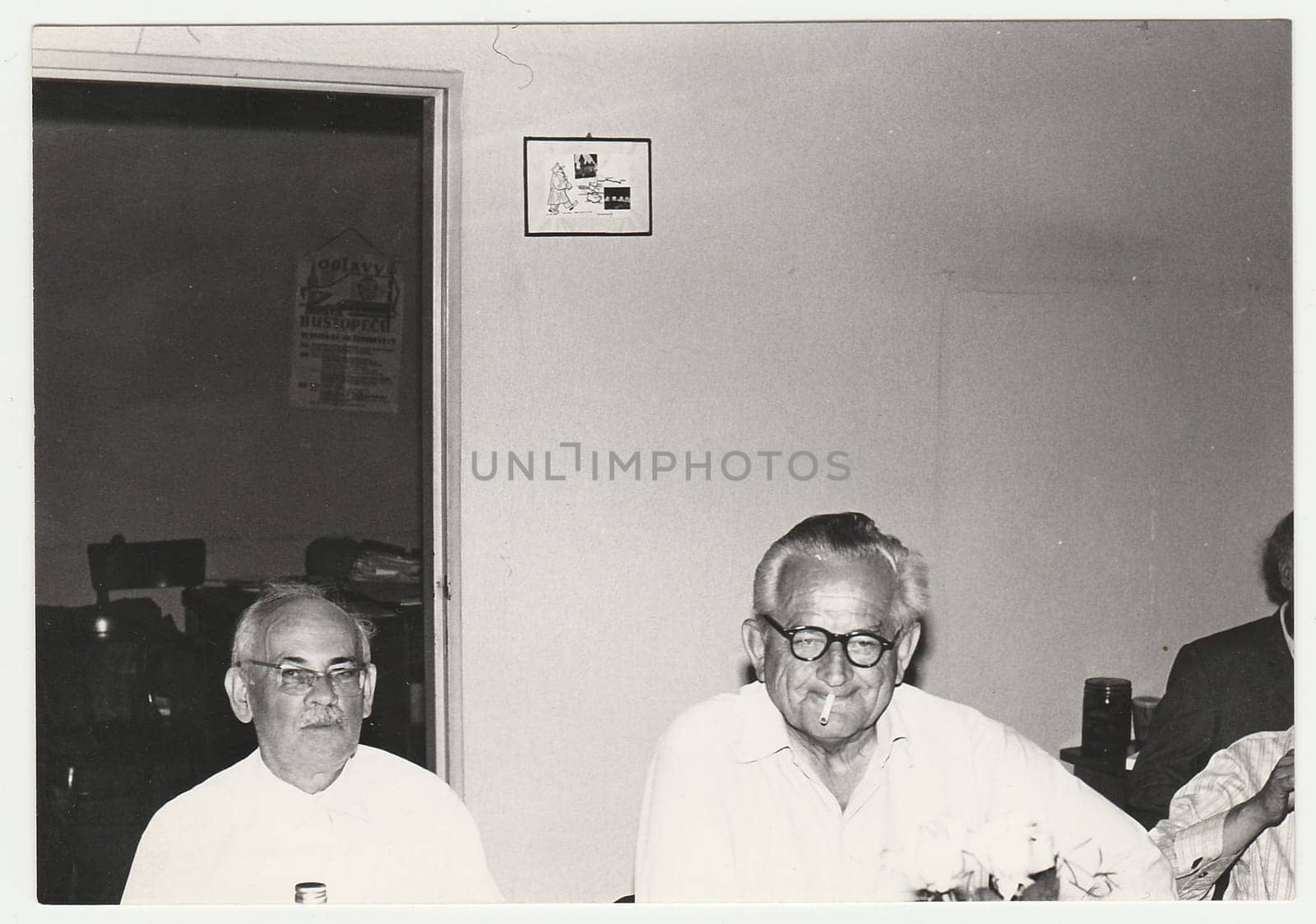 Vintage photo shows men in the office, circa 1980s. by roman_nerud