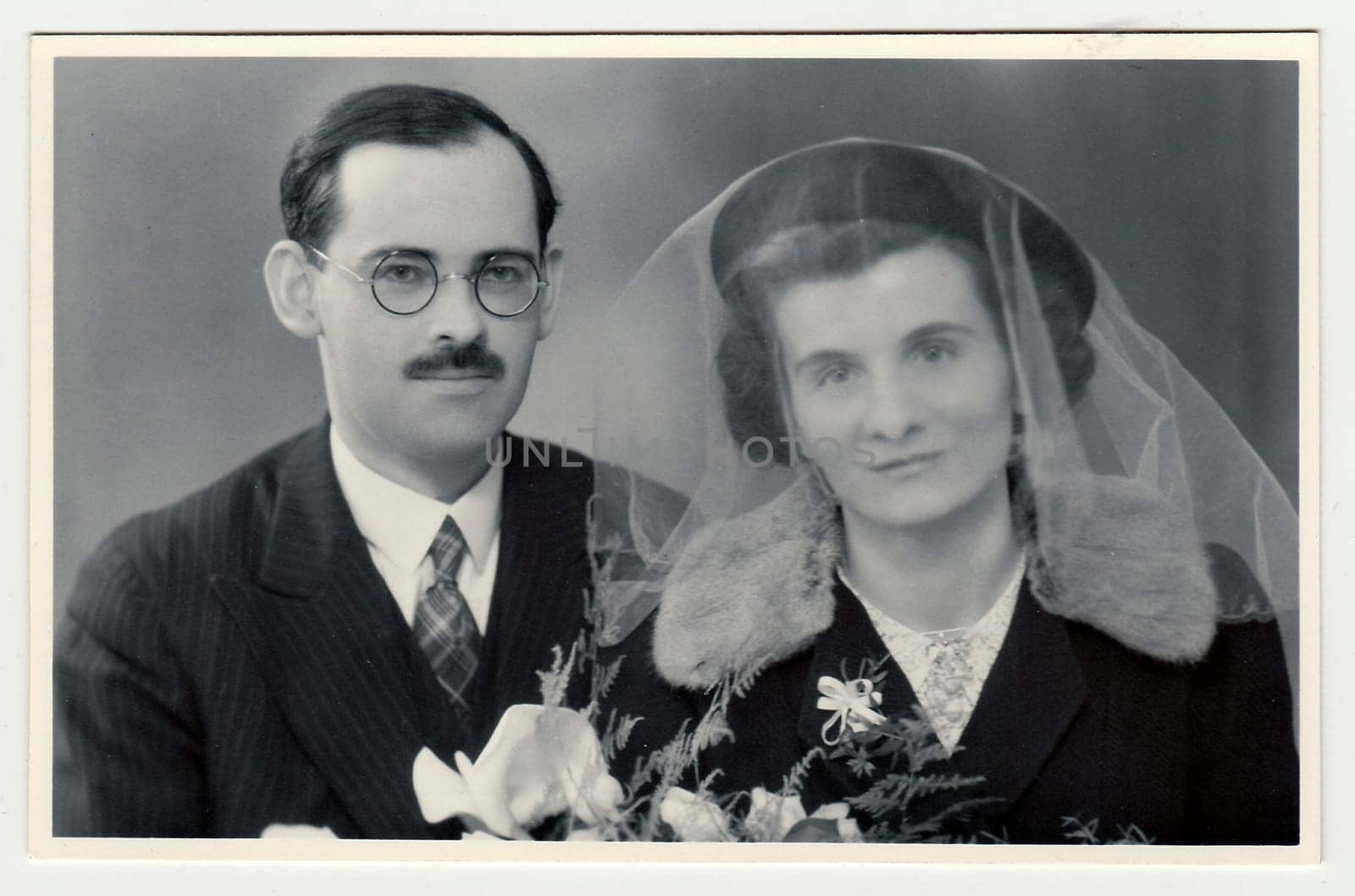 A vintage photo shows wedding portrait of newly-weds, circa 1935. by roman_nerud