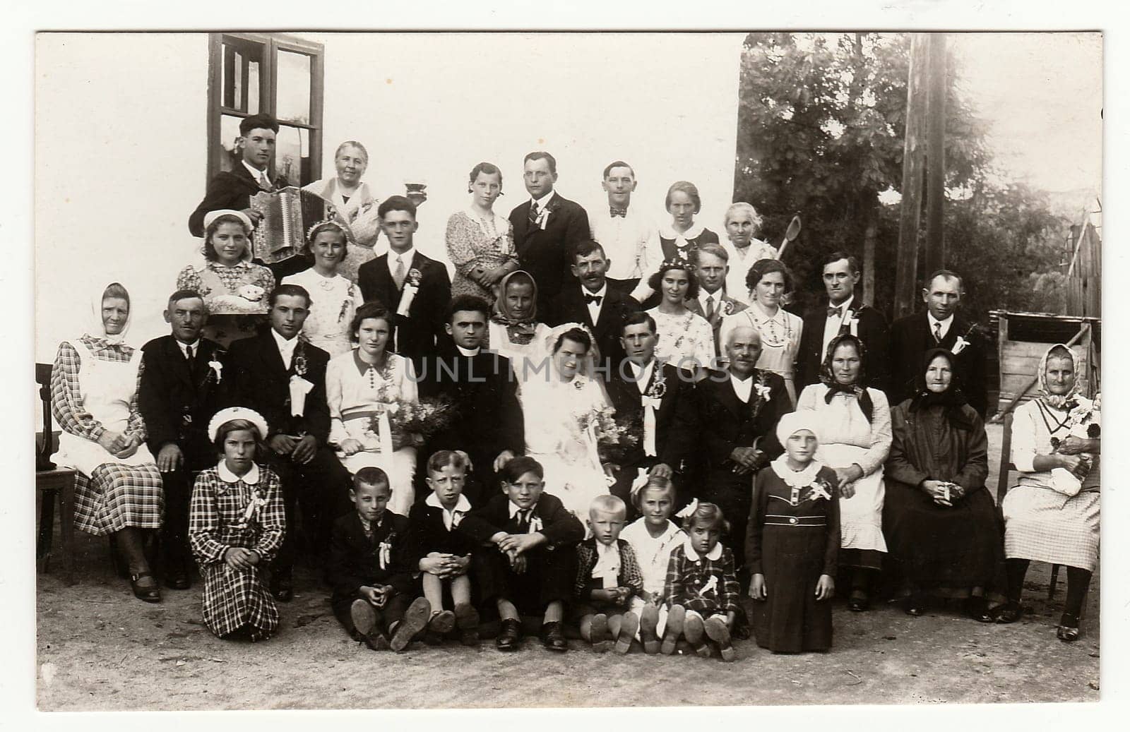 A vintage photo shows people in the back yard (during rural wedding feast), circa 1920. by roman_nerud