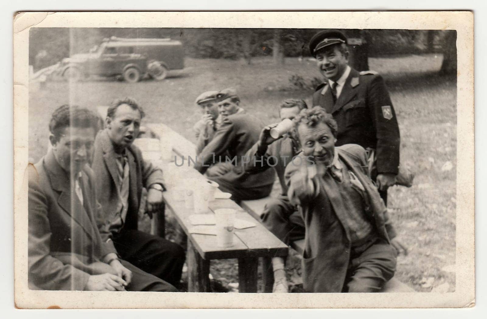 A vintage photo shows men in the nature, circa 1965. by roman_nerud