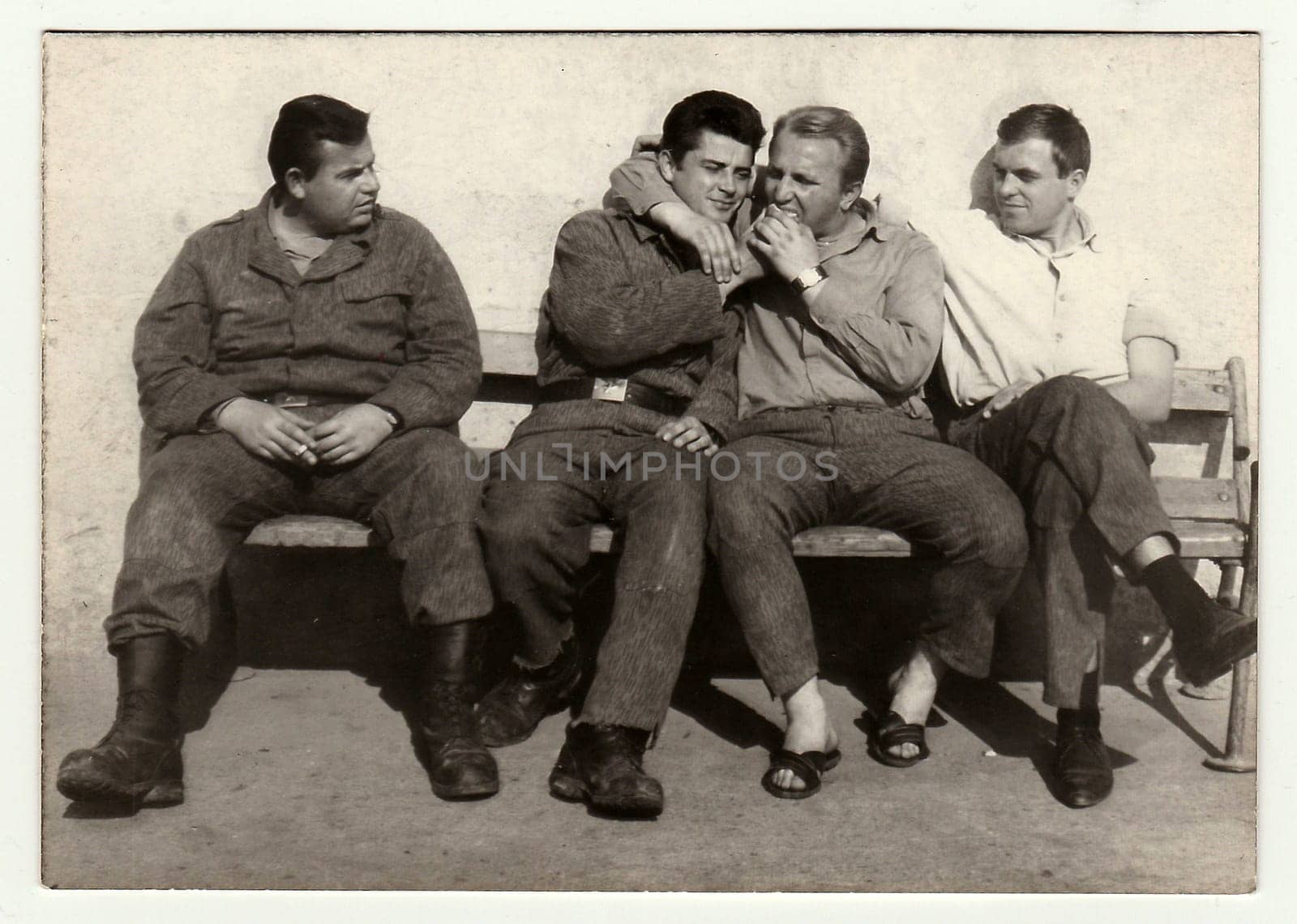 A vintage photo shows soldiers during a rest. by roman_nerud