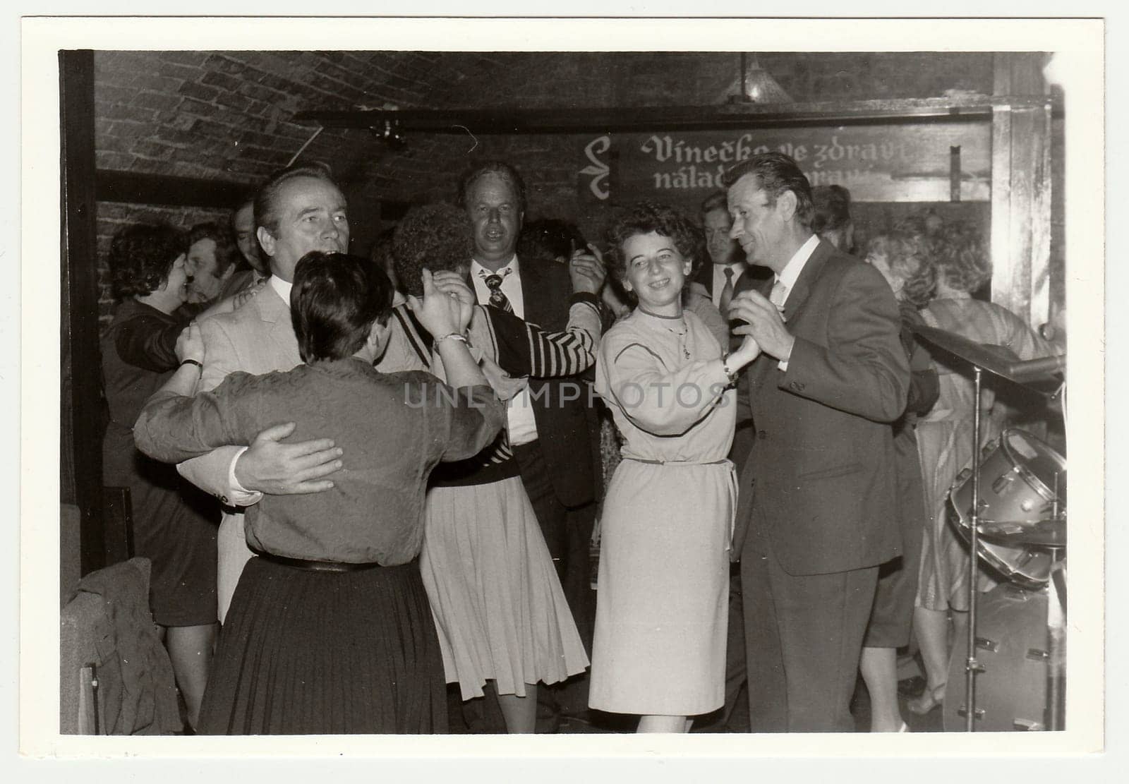 Vintage photo shows people dance in a wine bar. by roman_nerud