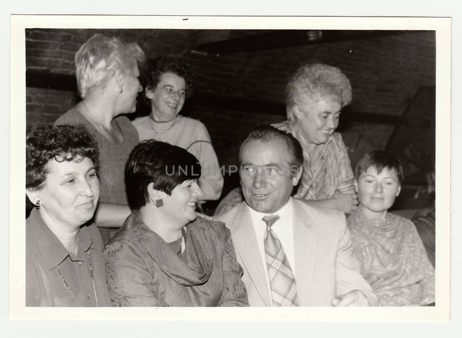 Vintage photo shows a group of people in a wine bar. by roman_nerud