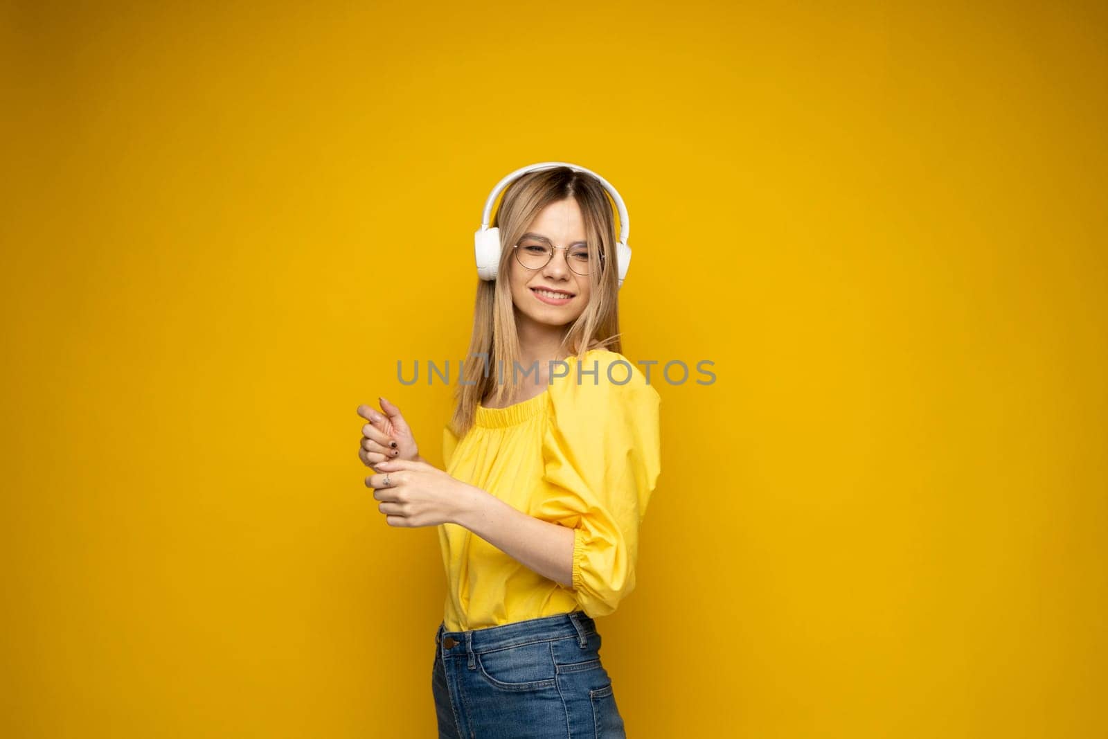 Young beautiful woman in bright outfit enjoying a music. by vovsht