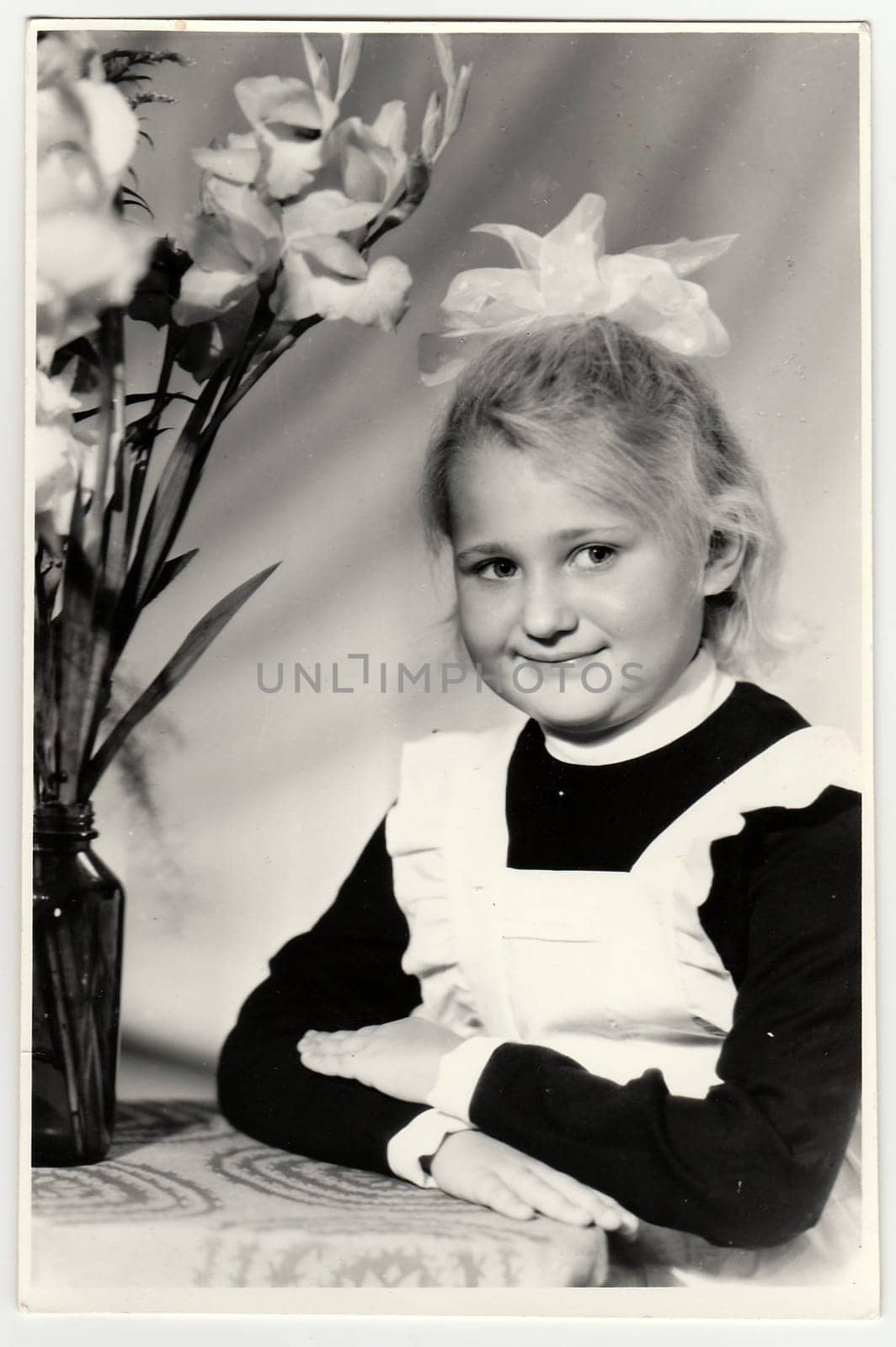 Vintage portrait of schoolgirl with ribbon on hair. by roman_nerud