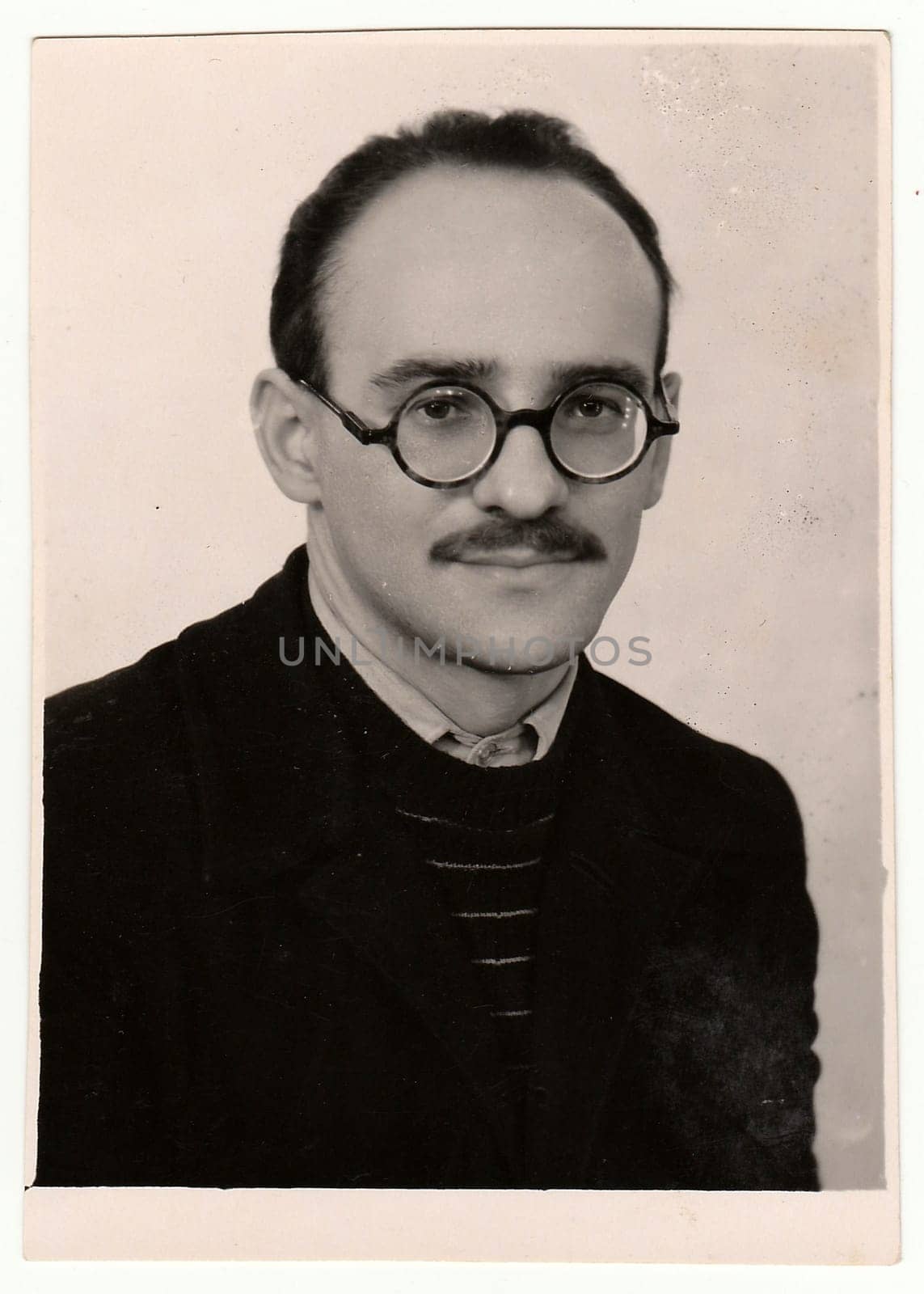 Vintage portrait of a young man with glasses and moustache. by roman_nerud