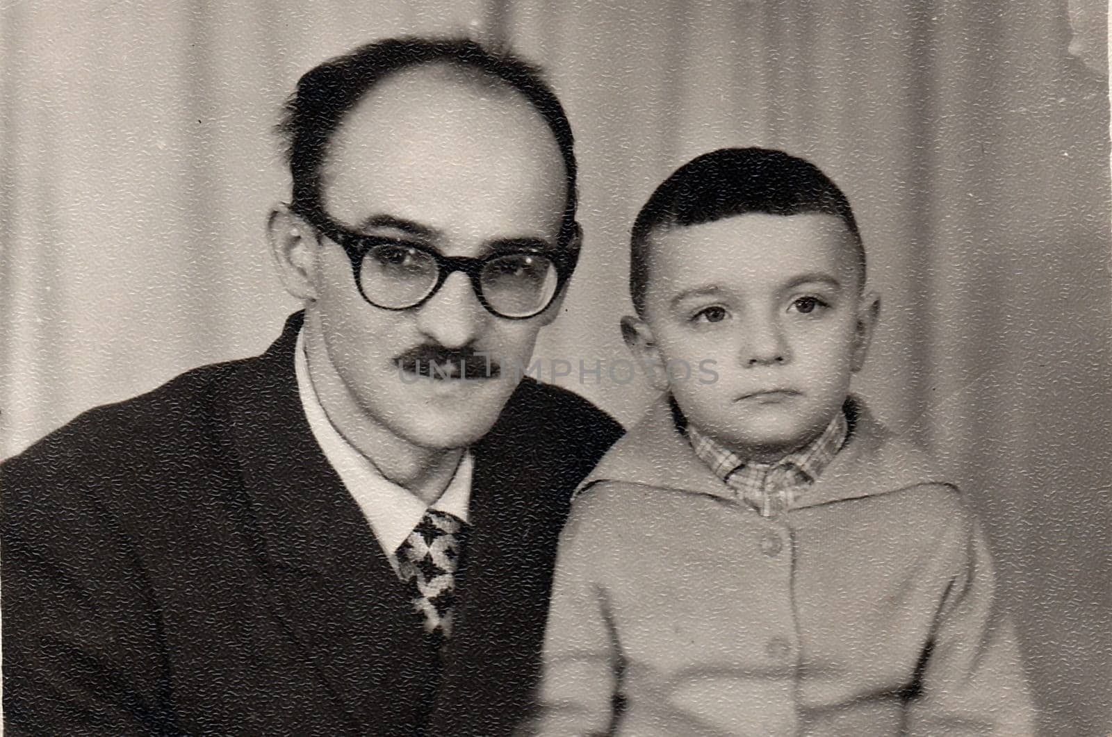 RYBINSK, USSR - CIRCA 1960s: Vintage photo of father with son.