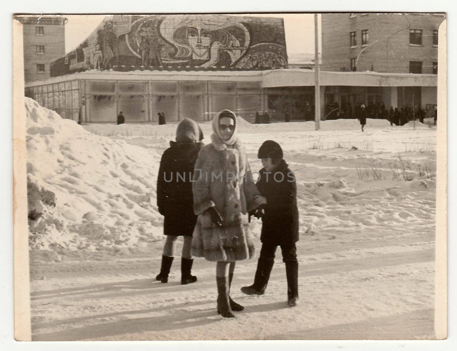 Vintage photo shows girl poses on street in winter. by roman_nerud