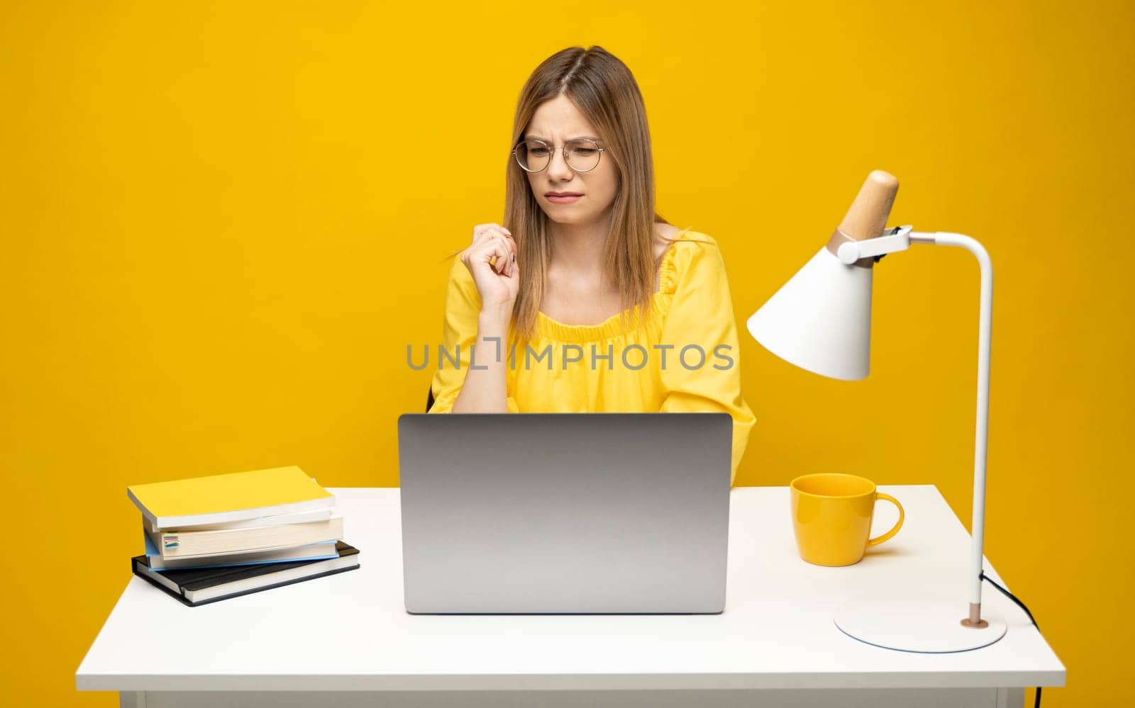 Frustrated, sad, stressed or depressed woman feeling tired while working with a laptop on a black background
