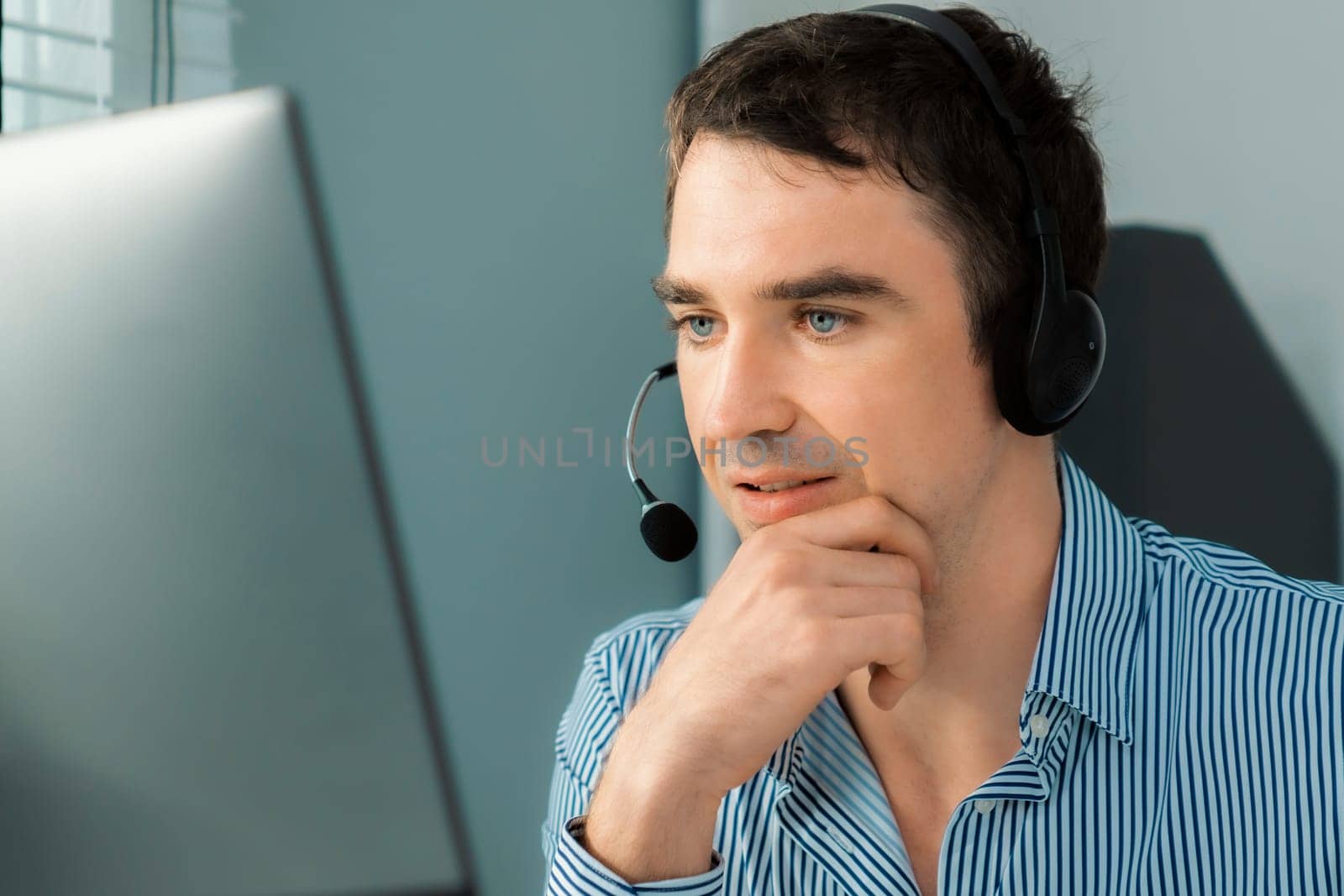 Competent male operator working with customers in the office. Concept of an operator, customer service agent working in the office.