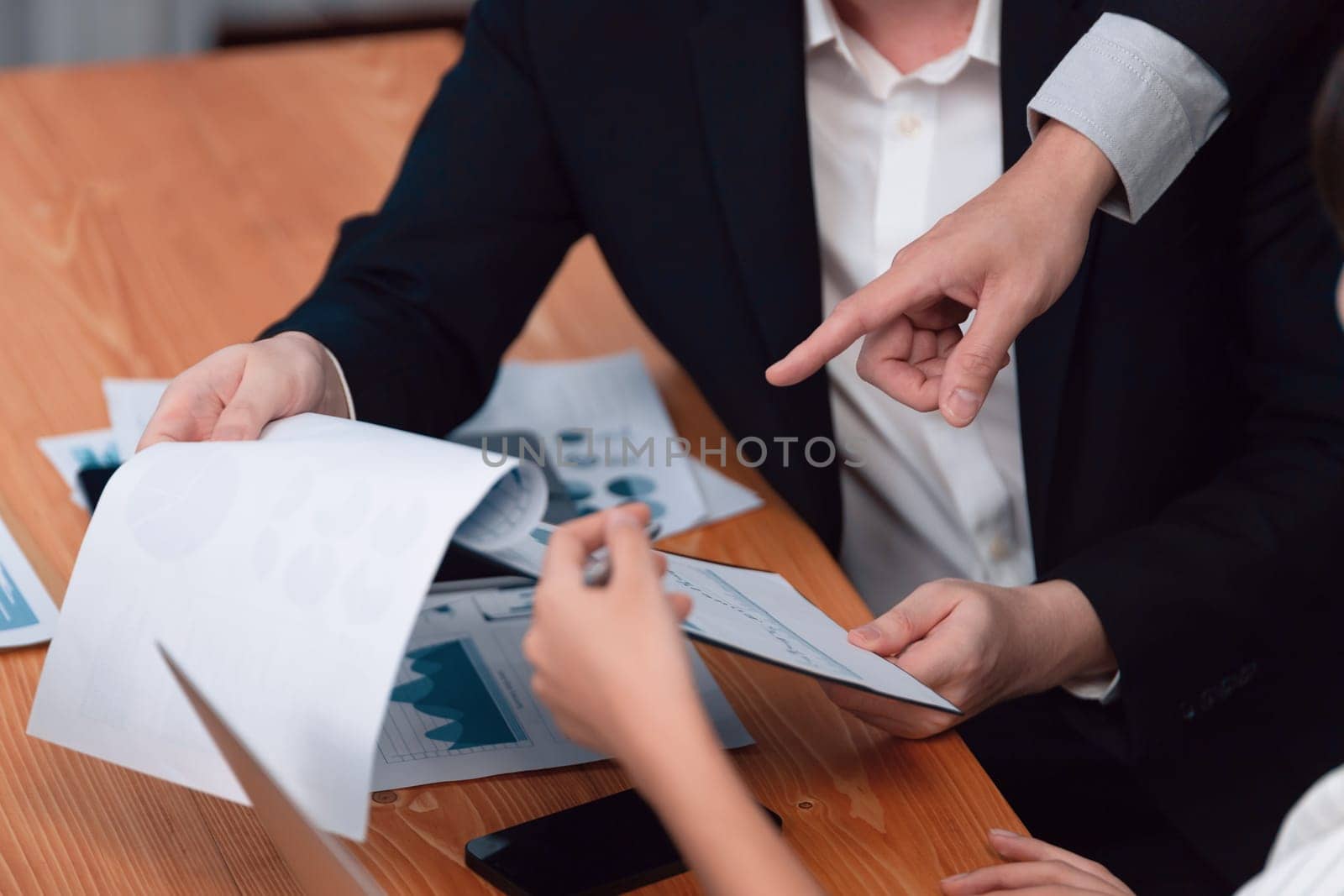 Harmony in office concept as business people analyzing dashboard paper together in workplace. Young colleagues give ideas at manager desk for discussion or strategy planning about project.