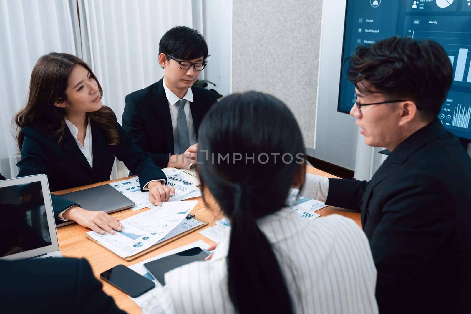 Business team of financial data analysis meeting with business intelligence, report paper and dashboard on laptop for marketing strategy. Business people working together to promote harmony in office.