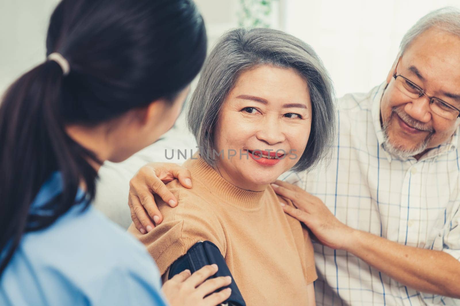 An elderly woman with a contented life having a blood pressure check. by biancoblue