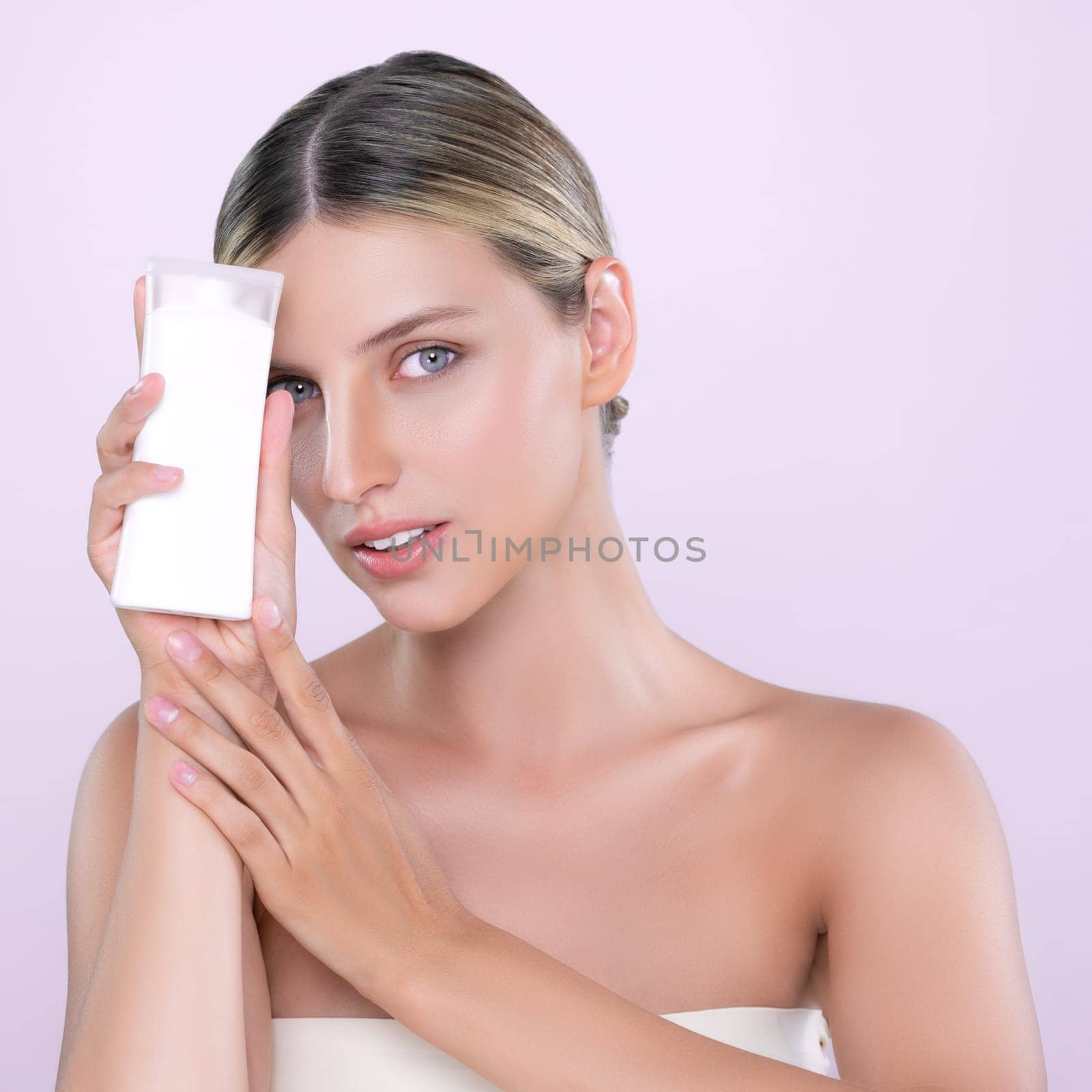 Alluring portrait of perfect skin woman holding mockup moisturizer tube. by biancoblue