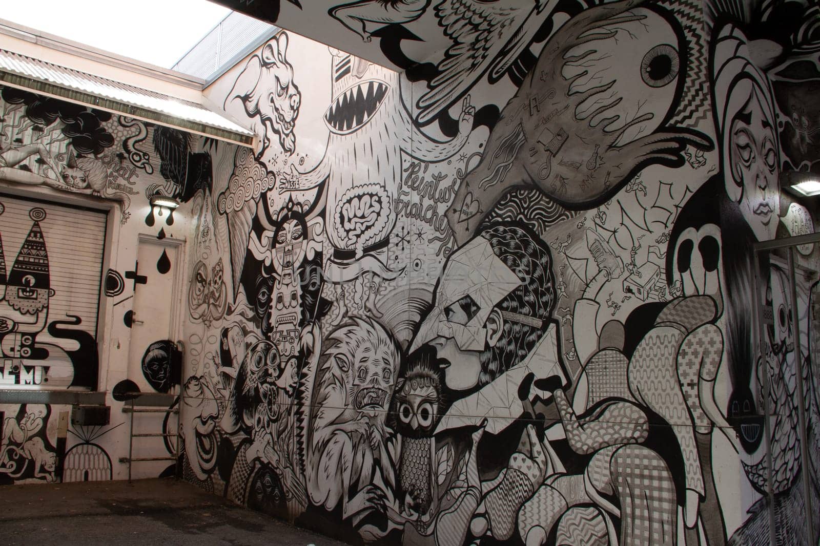 Creative black and white graffiti street art mural lining the street of Montreal, city of Quebec, Canada