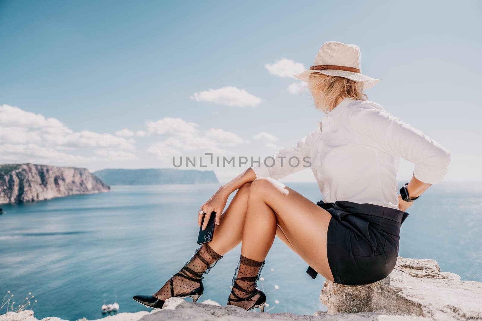 Happy girl doing yoga with laptop working at the beach. beautiful and calm business woman sitting with a laptop in a summer cafe in the lotus position meditating and relaxing. freelance girl remote work beach paradise