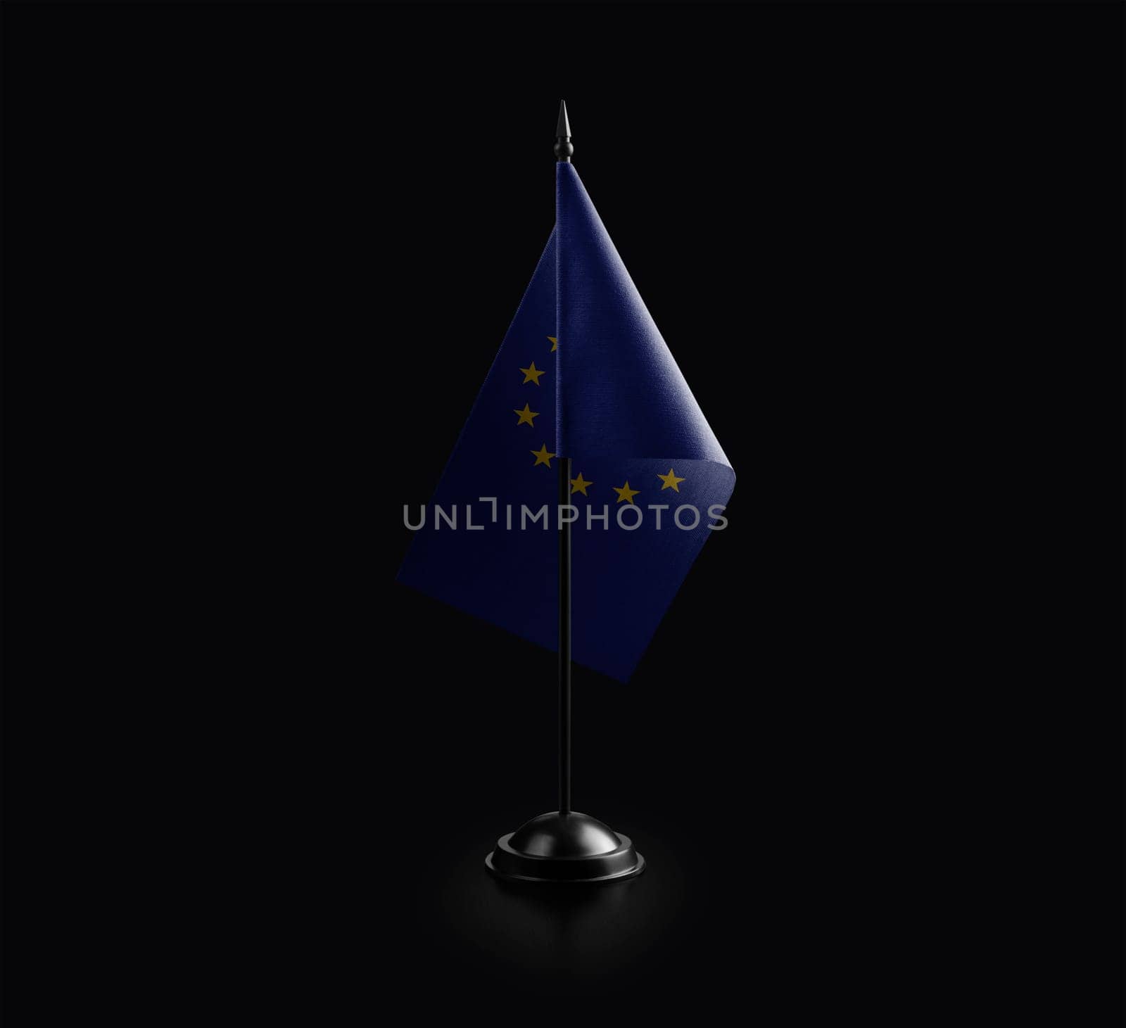 Small national flag of the European Union on a black background.