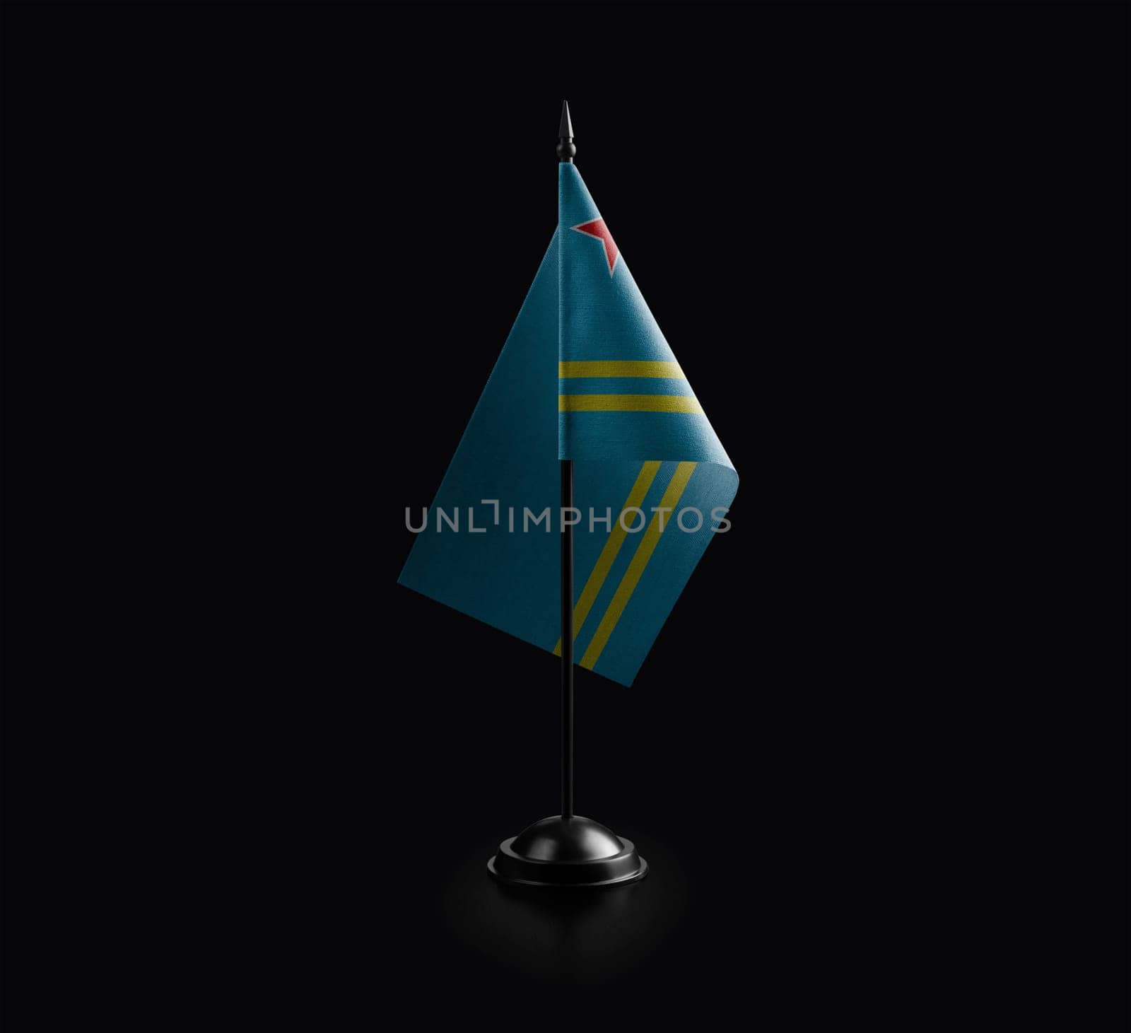 Small national flag of the Aruba on a black background.