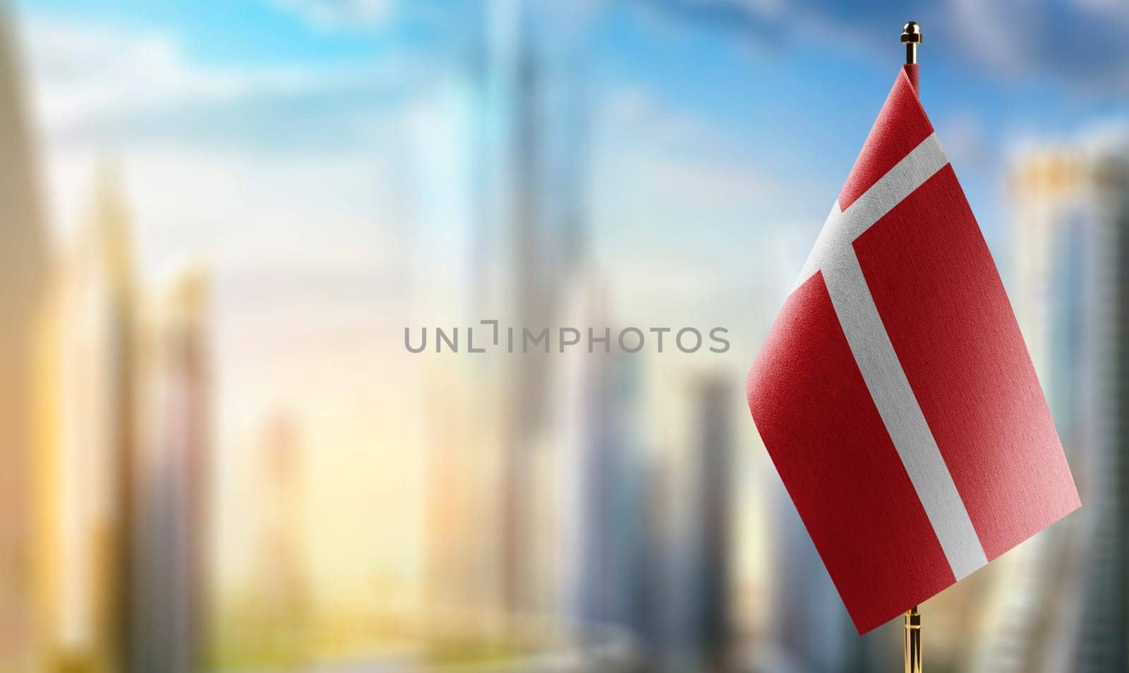 Small flags of the Denmark on an abstract blurry background.
