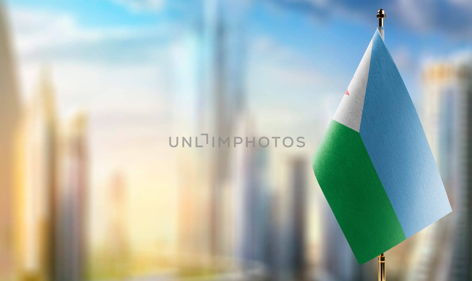 Small flags of the Djibouti on an abstract blurry background.